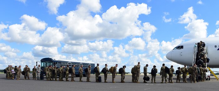 Deploying service members board an aircraft in preparation to deploy through Joint Base Charleston Oct. 15, 2018 in support of the Naval Station Norfolk air terminal while their airfield under goes scheduled maintenance.