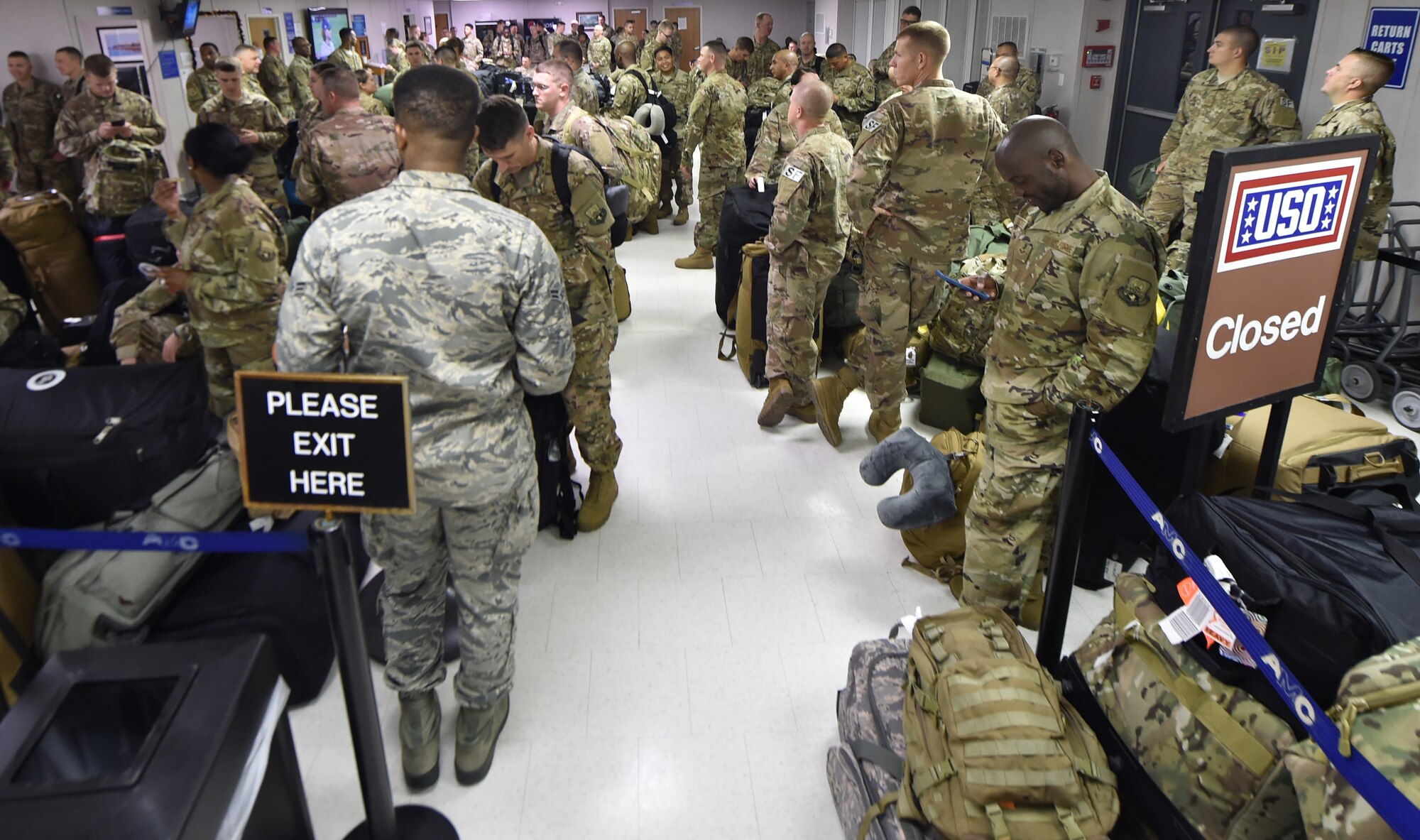 Passengers crowd the Joint Base Charleston Temporary Passenger Terminal as they wait to be processed as part of a mission to deploy service members through Joint Base Charleston Oct. 15, 2018, in support of the Naval Station Norfolk air terminal while their airfield undergoes scheduled maintenance.