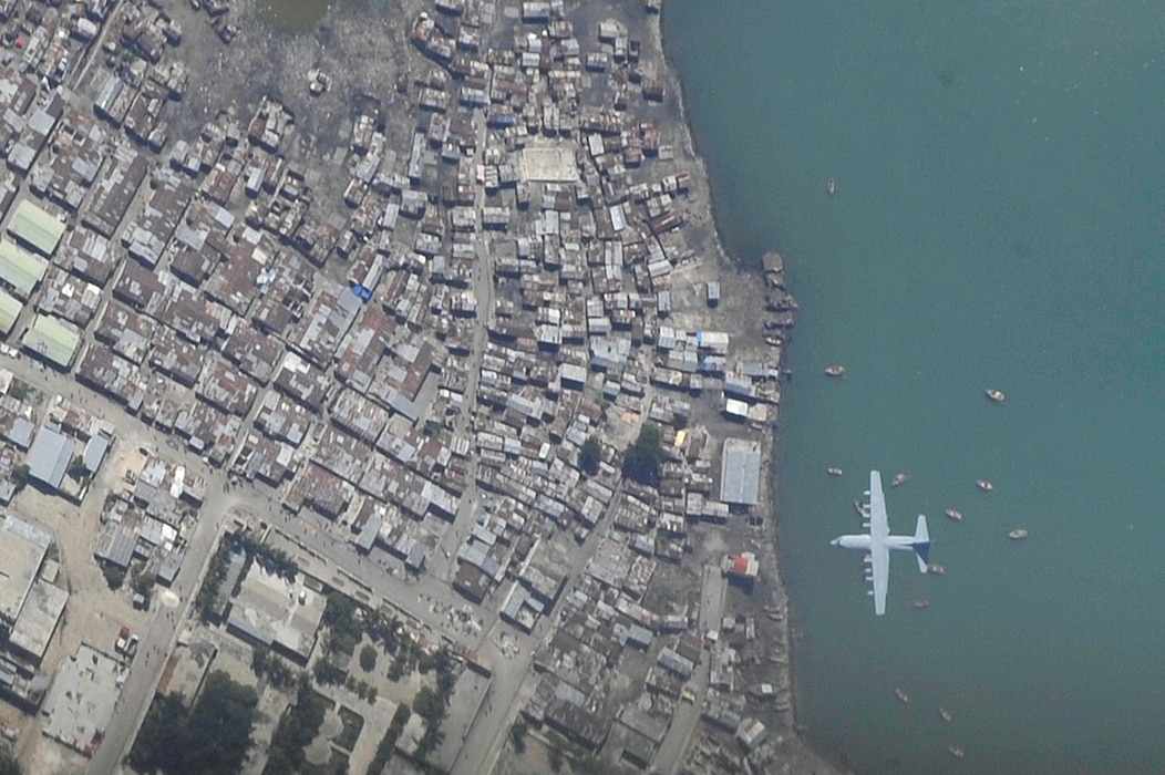 A C-130 Hercules aircraft makes a final approach into Toussaint Louverture International Airport in Port-au-Prince, Haiti, Jan. 16, 2010, part of the relief effort that delivered critical medical personnel and supplies after the area was hit by a 7.0 earthquake. (U.S. Air Force photo by Airman 1st Class Perry Aston)