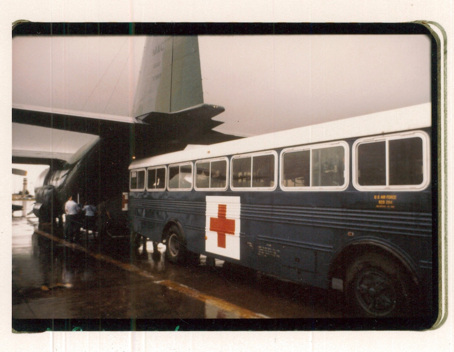 A hospital bus backs up to a C-130 Hercules aircraft to transport victims of the Pines Hotel fire to the regional medical center, Clark Air Base, Philippines, Oct. 23, 1984. (Courtesy photo)