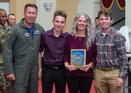 Maj. Gen. Patrick Doherty, 19th Air Force commander, posthumously presents the C-130H High Flyer Award to the wife and sons of Lt. Col. Reagan K. Whitlow, Deeanne, Koby and Kale Whitlow during the Air Education and Training Command Flying Training Awards Ceremony Oct. 26, 2018, at Joint Base San Antonio-Randolph, Texas. The award ceremony recognizes individuals, squadrons, groups and wings whose efforts have led to the highest levels of student production.