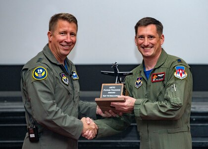Maj. Gen. Patrick Doherty, 19th Air Force commander, presents the Top T-6 Squadron Award to Lt. Col. Loren Coulter, 33rd Flying Training Squadron commander, during the Air Education and Training Command Flying Training Awards Ceremony Oct. 26, 2018, at Joint Base San Antonio-Randolph, Texas. The award ceremony recognizes individuals, squadrons, groups and wings whose efforts have led to the highest levels of student production.