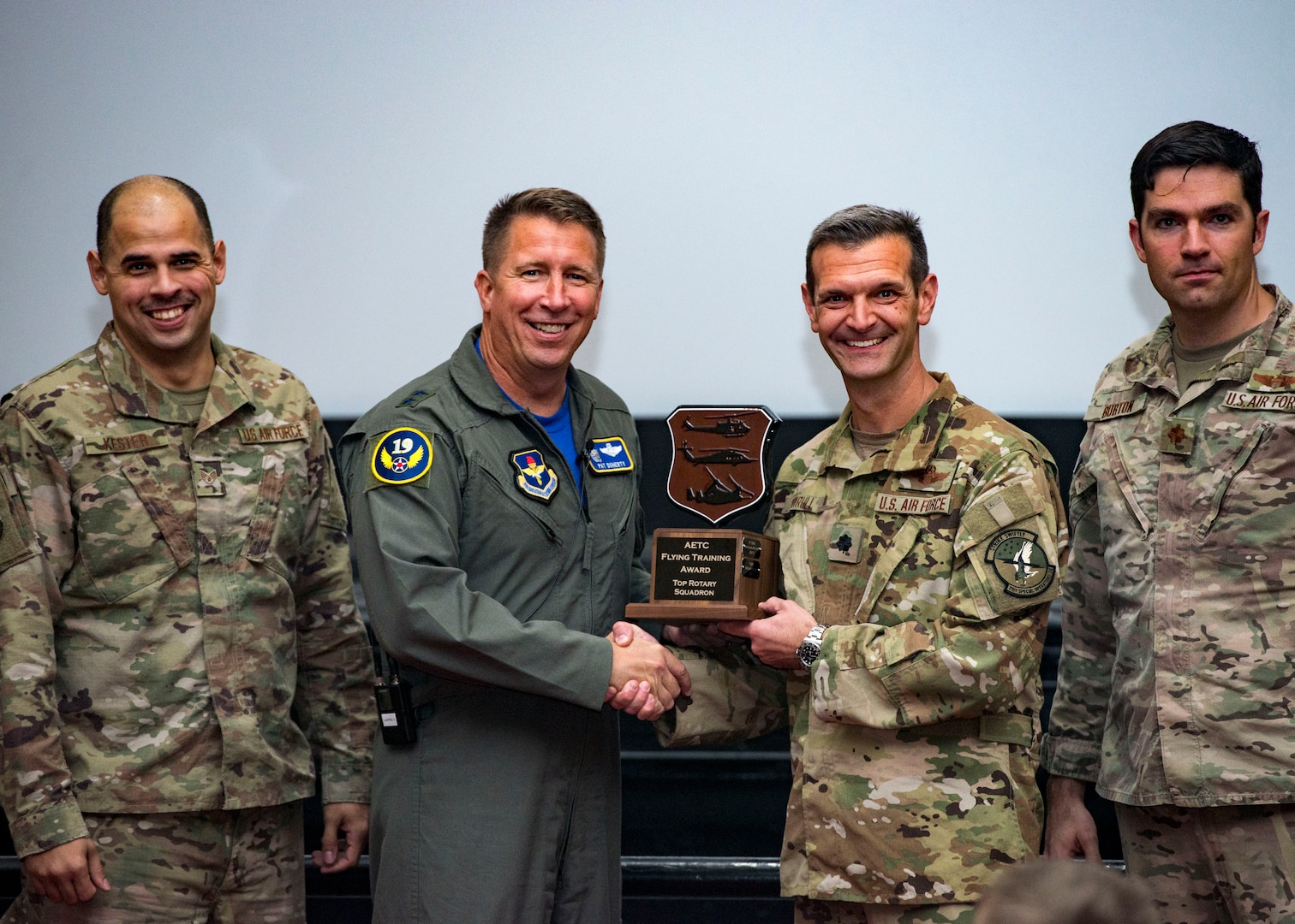 Maj. Gen. Patrick Doherty, 19th Air Force commander, presents the Top Rotary Squadron Award to Lt. Col. Matthew Shrull, 71ST Special Operations Squadron commander, during the Air Education and Training Command Flying Training Awards Ceremony Oct. 26, 2018, at Joint Base San Antonio-Randolph, Texas. The award ceremony recognizes individuals, squadrons, groups and wings whose efforts have led to the highest levels of student production.