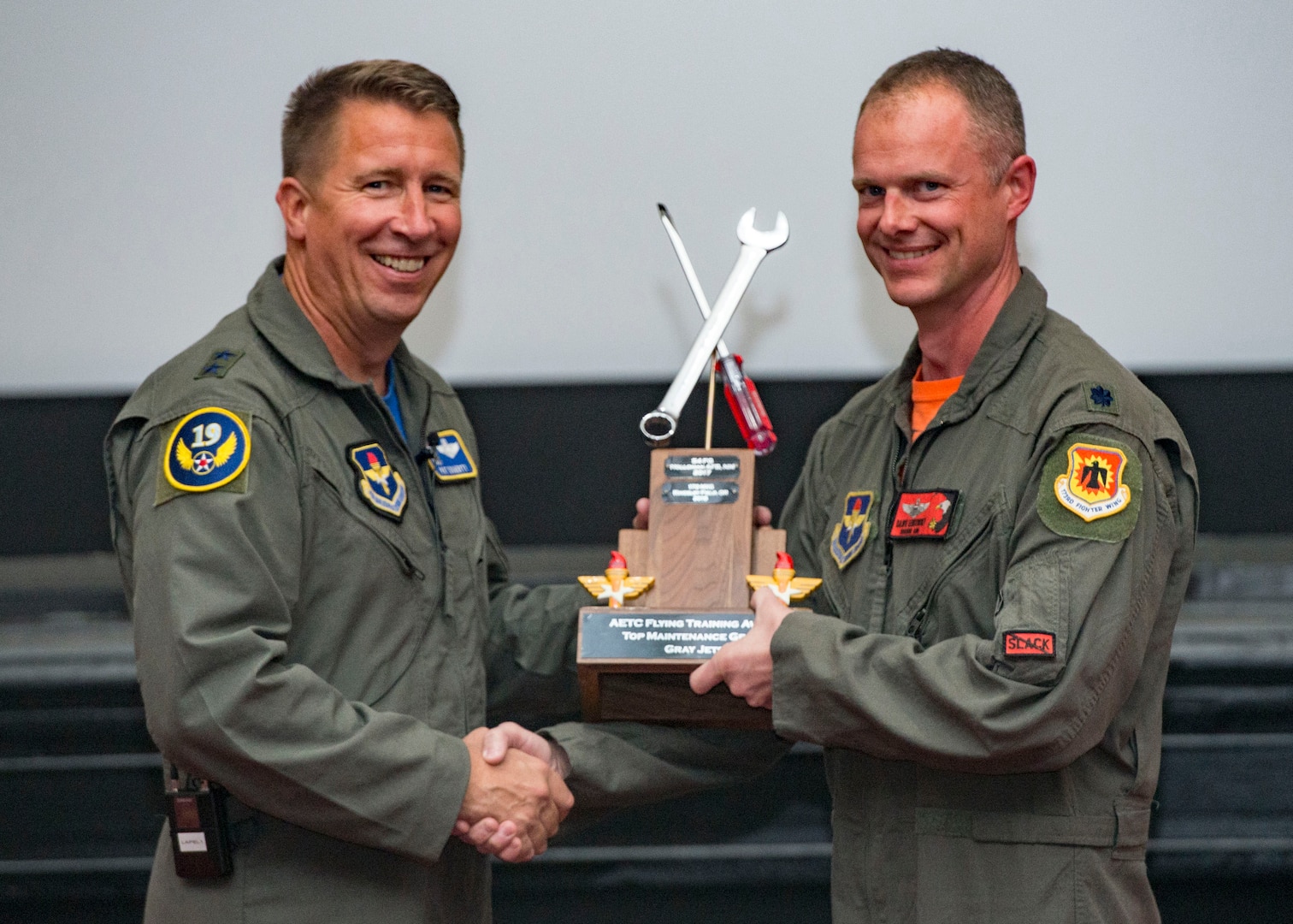 Maj. Gen. Patrick Doherty, 19th Air Force commander, presents the Top Maintenance Organization-Gray Jet Division Award to Lt. Col. Michael Lambert, 173rd Maintenance Group commander, during the Air Education and Training Command Flying Training Awards Ceremony Oct. 26, 2018, at Joint Base San Antonio-Randolph, Texas. The award ceremony recognizes individuals, squadrons, groups and wings whose efforts have led to the highest levels of student production.