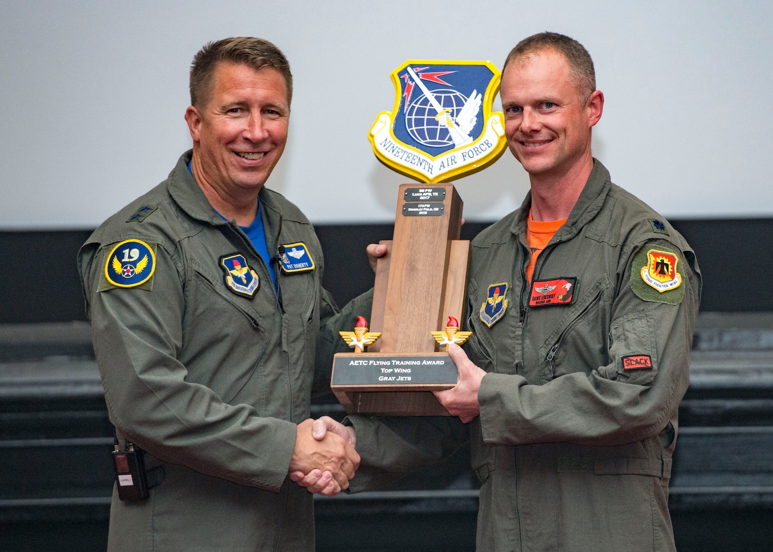 Maj. Gen. Patrick Doherty, 19th Air Force commander, presents the Top Wing-Gray Jet Division Award to the 173rd Fighter Wing commander, during the Air Education and Training Command Flying Training Awards Ceremony Oct. 26, 2018, at Joint Base San Antonio-Randolph, Texas. The award ceremony recognizes individuals, squadrons, groups and wings whose efforts have led to the highest levels of student production.