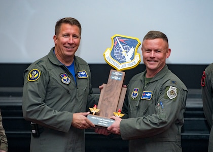 Maj. Gen. Patrick Doherty, 19th Air Force commander, presents the Top Wing-Gray Tail Division Award to Col. Doug Horne, 58th Special Operations Wing, during the Air Education and Training Command Flying Training Awards Ceremony Oct. 26, 2018, at Joint Base San Antonio-Randolph, Texas. The award ceremony recognizes individuals, squadrons, groups and wings whose efforts have led to the highest levels of student production.