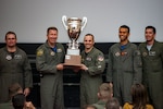 Maj. Gen. Patrick Doherty, 19th Air Force commander, presents the Top Wing of Wings Award to Col. Corey Simmons, 71st Flying Training Wing commander, during the Air Education and Training Command Flying Training Awards Ceremony Oct. 26, 2018, at Joint Base San Antonio-Randolph, Texas. The award ceremony recognizes individuals, squadrons, groups and wings whose efforts have led to the highest levels of student production.