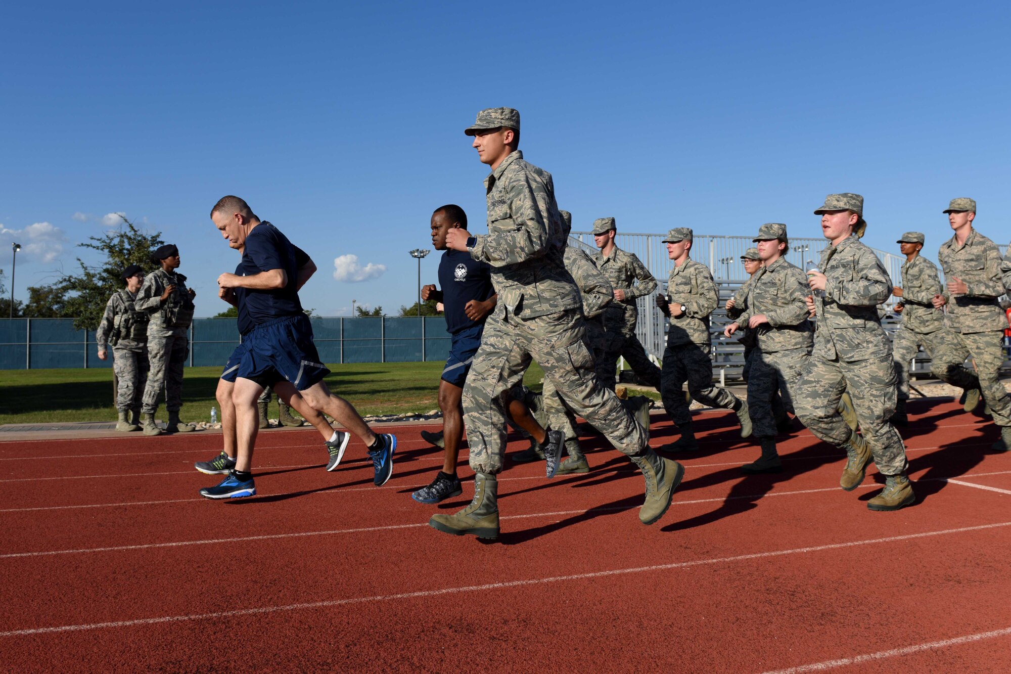 Airmen from the 315th Training Squadron run during the 24-hour Prisoners of War and Missing in Action Vigil at the track on Goodfellow Air Force Base, Texas, Oct. 26, 2018. Individuals carried the baton for 24 hours, passing it to others while running to ensure that it didn’t stop moving. (U.S. Air Force photo by Senior Airman Randall Moose/Released)