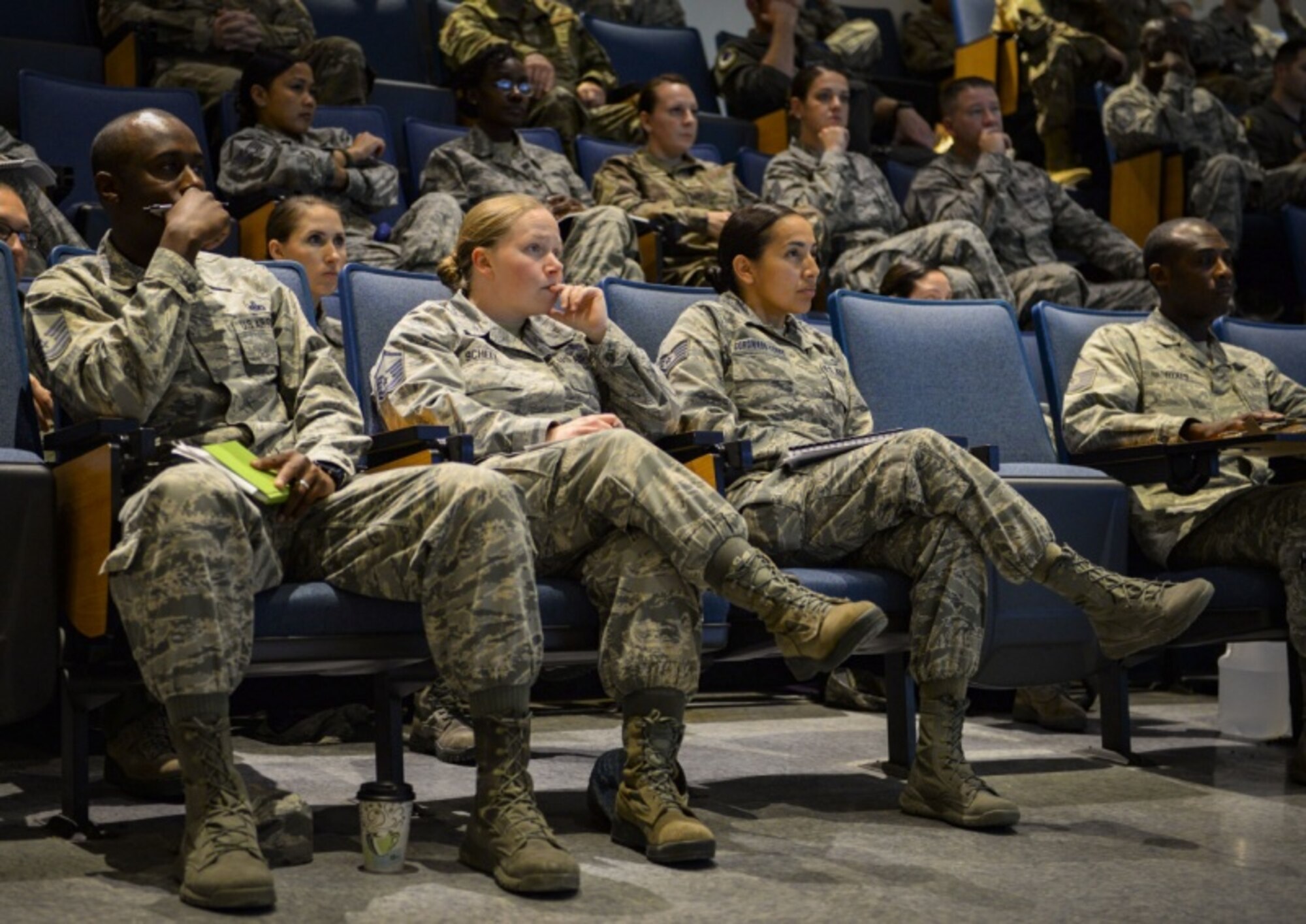 Non-commissioned officers attending the Nellis/Creech Superintendent Symposium sit through a briefing during the Nellis/Creech Superintendent Symposium Oct. 23, 2018 on Nellis Air Force Base, Nevada. Throughout the symposium, attendees participated in multiple panels, briefings and activities designed to provide them with the essential information, reassurance and experience needed for their superintendent roles. (U.S. Air Force photo by Airman Bailee A. Darbasie)