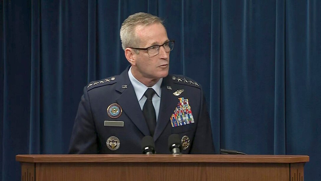 An Air Force general speaks at a lectern.