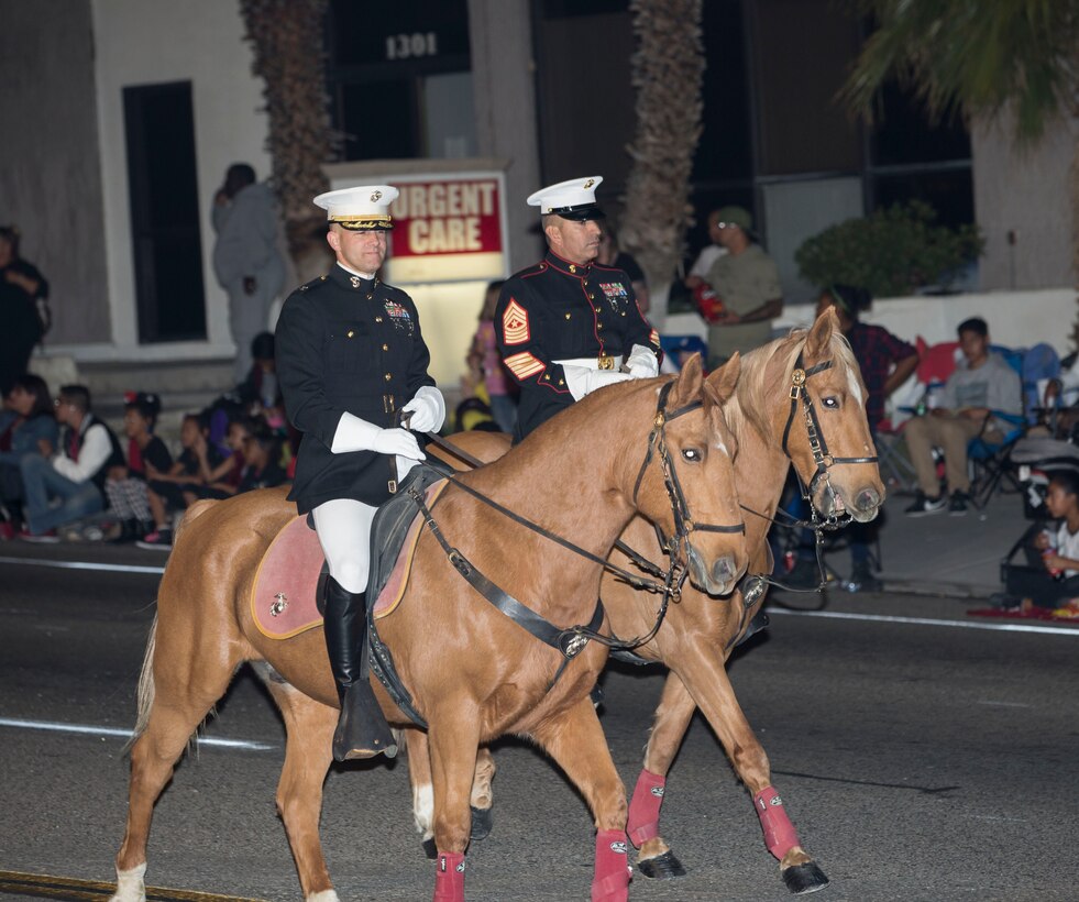 Col. Craig Clemans, MCLB Barstow base commander, and SgtMaj. Sergio Martinezruiz, base sergeant major, lead the 86th annual Kiwanis Club Mardi Gras Parade, down Main Street in Barstow, Calif. Oct. 27
