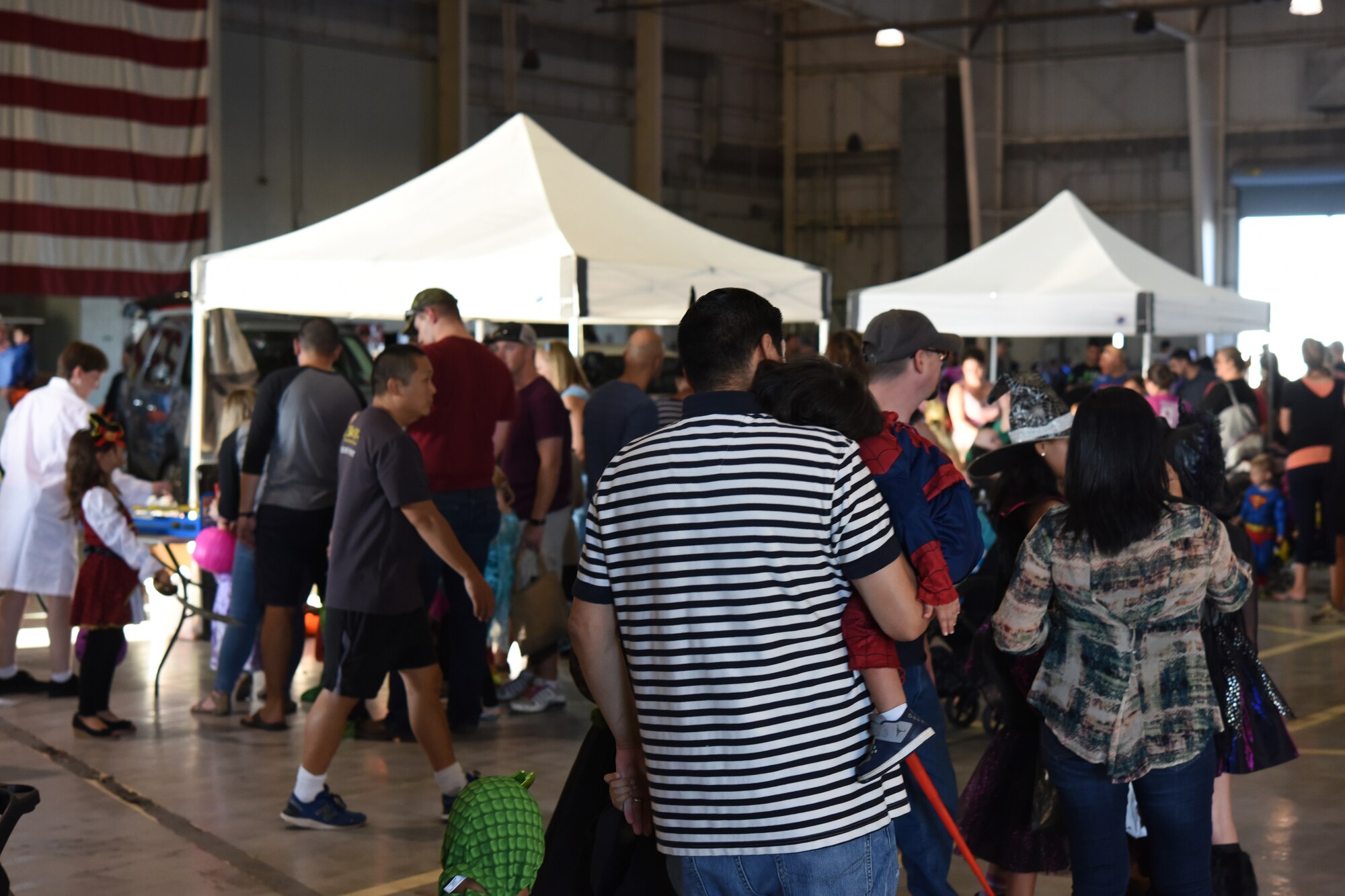Families wait to join in the carnival games during Ghoulfellow in the Louis F. Garland Department of Defense Fire Academy on Goodfellow Air Force Base, Texas, Oct. 27, 2018. Along with booths and games, the children also had a chance to join in Trunk or Treat and a hay ride. (U.S. Air Force photo by Airman 1st Class Zachary Chapman/Released)