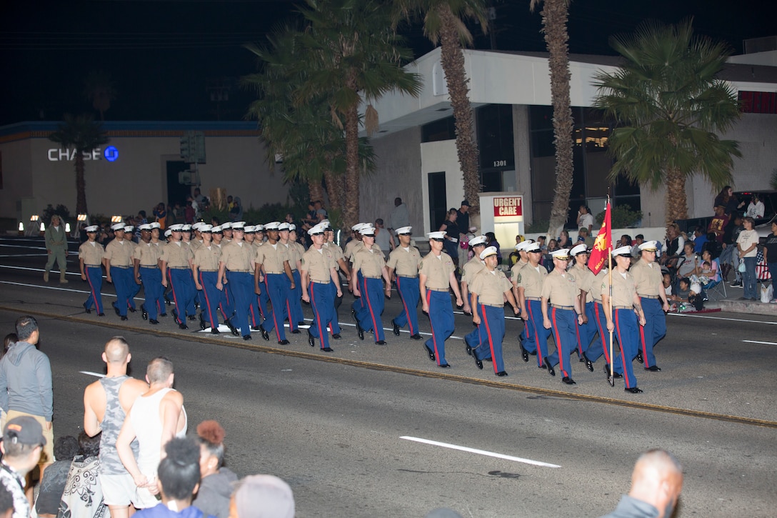 Marines of Headquarters Company, Marine Corps Logistics Base Barstow, strut their stuff during the 86 annual Kiwanis Club Mardi Gras Parade, in Barstow, Calif. Oct 27. The parade was originally held on Halloween but was changed to the weekend prior to allow the children to go trick or treating.