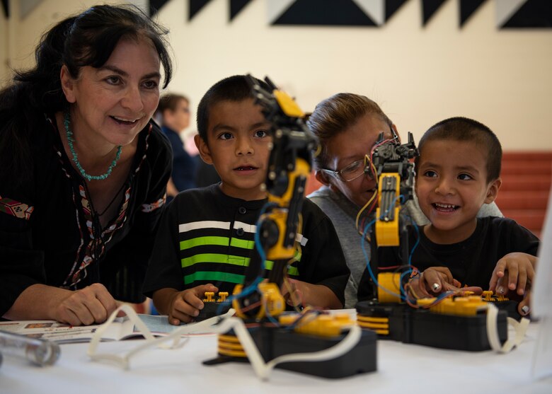 Cynthia Dominguez-Trujillo, 377th Air Base Wing Diversity and Affirmative Employment, teaches residents of the Acoma Pueblo how to operate robots during U.S. Air Force Day at Acoma Pueblo, N.M., Oct. 27, 2018. (U.S. Air Force photo by Staff Sgt. J.D. Strong II)