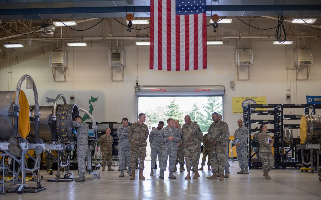 Master Sgt. Ryan Ross, center left, 35th Maintenance Squadron jet engine intermediate maintenance section chief, talks with Gen. CQ Brown, Jr., center right, Pacific Air Forces commander, and Chief Master Sgt. Anthony Johnson, right, PACAF command chief, during their tour of the installation at Misawa Air Base, Japan, Oct. 25, 2018. Ross explained the important role the centralized engine repair facility plays in the 35th Maintenance Group’s mission and the innovative Airmen experimenting with new ways of getting the job done. (U.S. Air Force photo by Tech. Sgt. Benjamin W. Stratton)