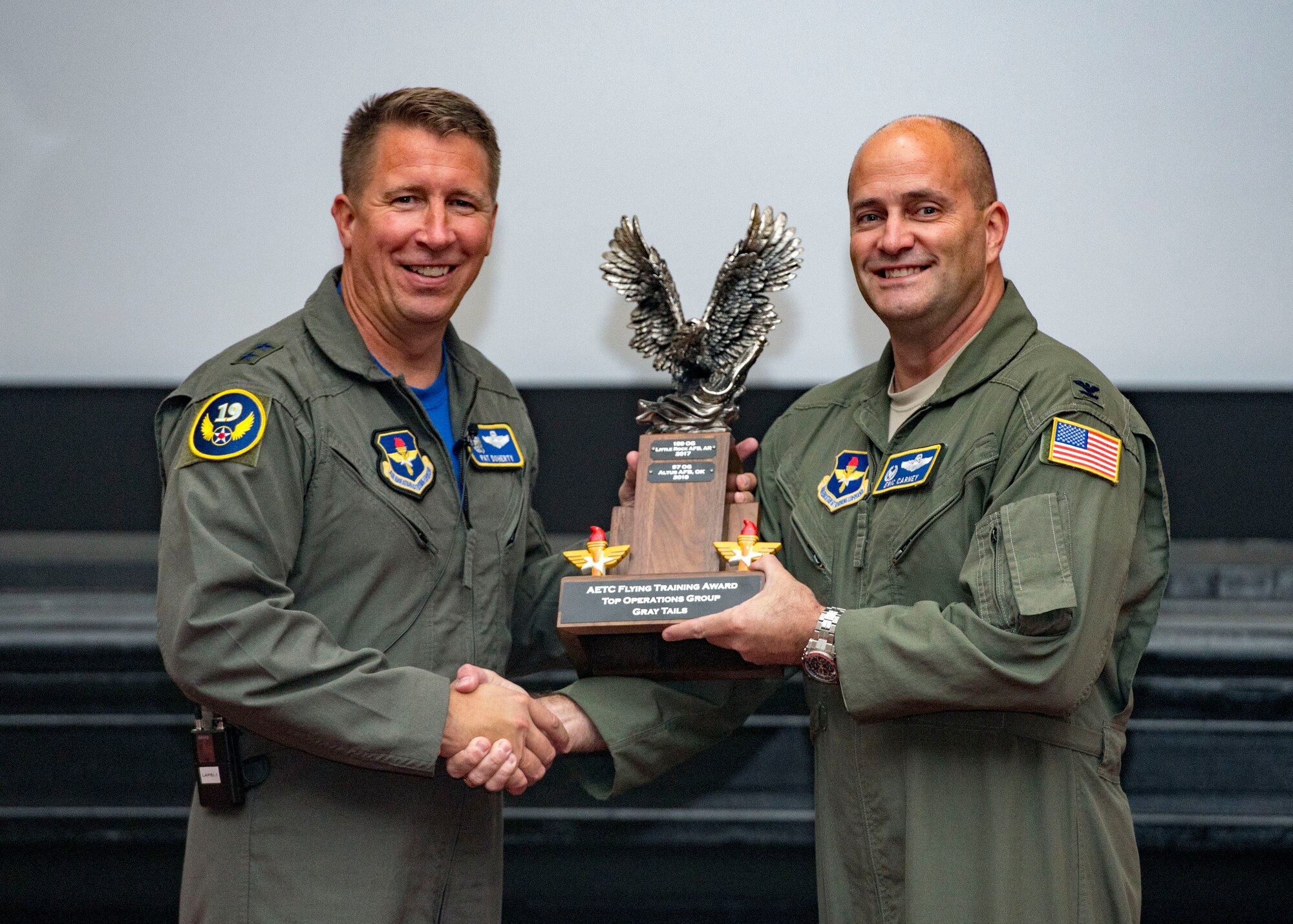 Maj. Gen. Patrick Doherty, 19th Air Force commander, presents the Top Operations Group-Gray Tail Division Award to the 97th Operations Group during the Air Education and Training Command Flying Training Awards Ceremony Oct. 26, 2018, at Joint Base San Antonio-Randolph, Texas. The award ceremony recognizes individuals, squadrons, groups and wings whose efforts have led to the highest levels of student production.