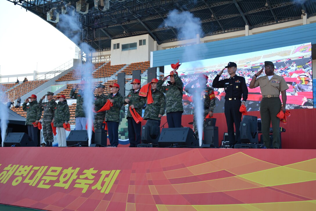 Republic of Korea (ROK) and U.S. Marines and civilian DVs salute during the 2018 Pohang Marine Corps Cultural Festival in Pohang, Republic of Korea, Oct. 20, 2018. The festival was held to display the capabilities of the ROK Marine Corps and celebrate the ROKMC. U.S. Marines from Camp Mujuk marched with the ROK Marines during the festival in order to display their partnership. (U.S. Marine Corps photo by Kyongcha Ha)