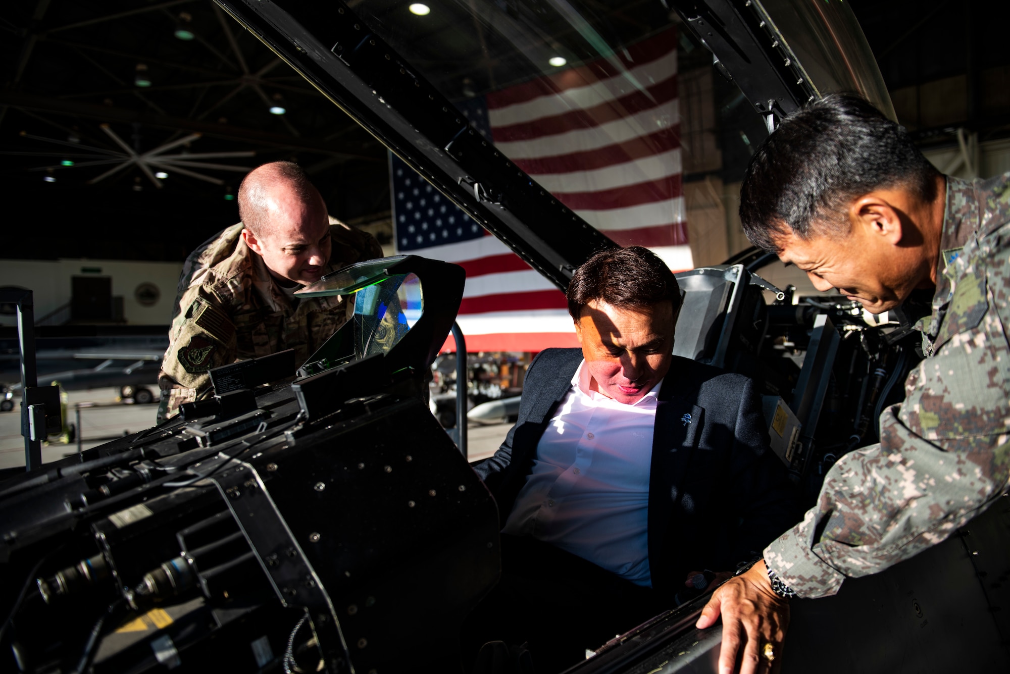 Col. John Bosone, 8th Fighter Wing commander (left) and Col. Jae-Gyun Jeon, 38th Fighter Group commander (right) seat Kang Imjune, Mayor of Gunsan (middle) in an F-16 Fighting Falcon at Kunsan Air Base, Republic of Korea. Mayor Imjune was shown the different ways Kunsan AB contributes to the overall safety and security of the Korean Peninsula with the help of Republic of Korea Air Force partners. (U.S. Air Force photo by Senior Airman Stefan Alvarez)