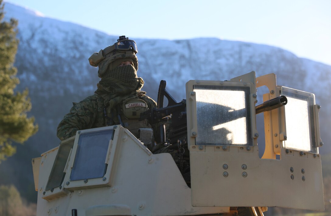 A U.S. Marine with 24th Marine Expeditionary Unit await commands atop a High Mobility Multipurpose Wheeled Vehicle during Exercise Trident Juncture 18 in Alvund, Norway, Oct. 29, 2018. Trident Juncture is a multinational NATO exercise that enhances professional relationships and improves overall coordination with Allied and partner nations.