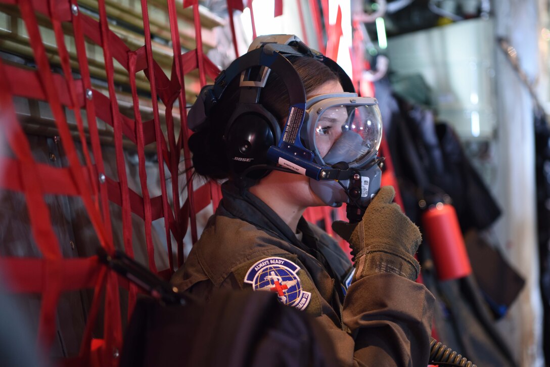 U.S. Air Force Tech. Sgt. Christine Williams, 86th Aeromedical Evacuation Squadron aeromedical  evacuation technician, secures her oxygen mask during an emergency procedures drill on a C-130J Super Hercules aircraft, Oct. 23, 2018. During the training mission, the aeromedical evacuation technicians practiced emergency procedures for fires and depressurization.