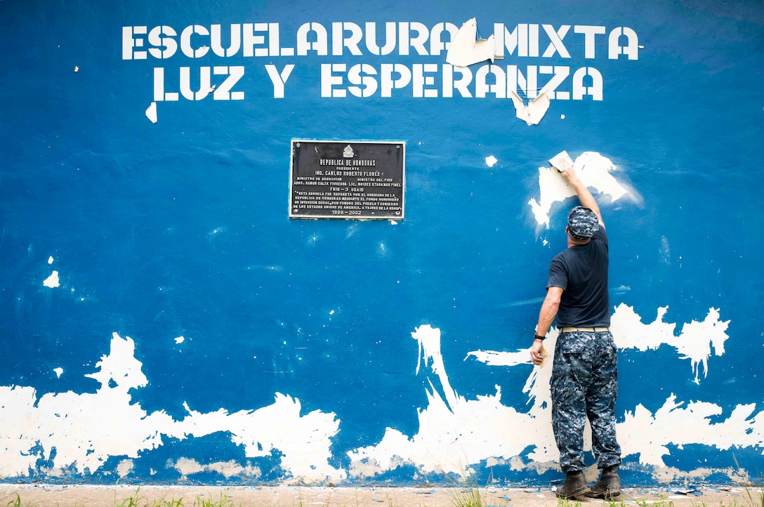 Chaplain prepares wall of school for new paint during community relations event supporting Southern Partnership Station 17, Colón, Honduras, August 9, 2017 (U.S. Navy/Kristen Cheyenne Yarber)