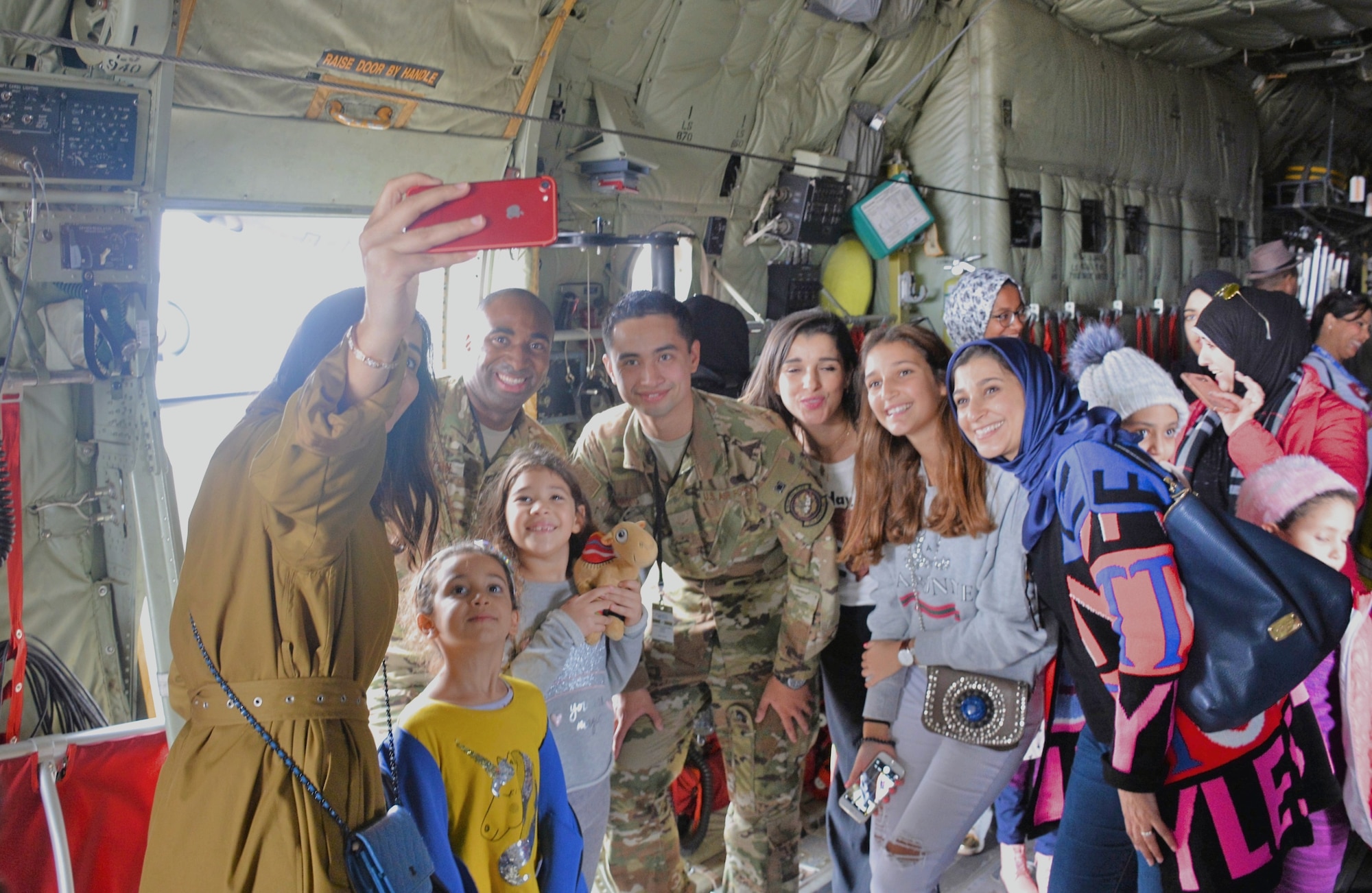 C-130 crewmembers SSgt Mario Linton (left) and A1C Alex Loberg from the 86th Airlift Wing, Ramstein Air Force Base, Germany, pose for a pictures with visitors at the Marrakech Air Show in Marrakech, Morocco. The air show drew hundreds of civilian and military aviation leaders and thousands of public visitors Oct. 24-27 to showcase leadership in aerospace technologies by the U.S., Morocco and other regional partners. Continued U.S participation in the Marrakech Air Show, held every two years since 2008, promotes strong ties with Morocco and demonstrates to large audiences that U.S. industry is producing the types of equipment that is critical to current and future military operations.