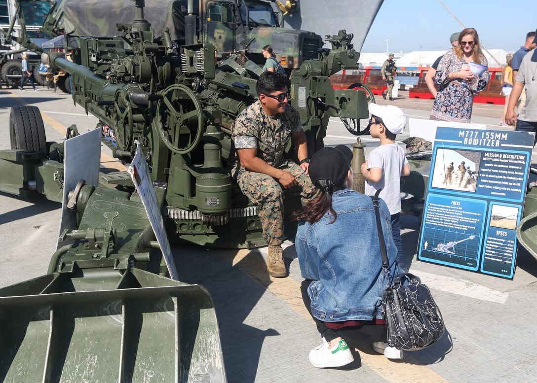 U.S. Marine Sgt. Jose Lopez, a field artillery cannoneer with 2nd battalion, 11th marines, 1st Marine Division, explains the capabilities of the M777 "Howitzer" during Fleet Week San Diego 2018, in San Diego, California, Oct. 27. Fleet Week San Diego 2018 gives service members the opportunity to show community involvement, develop stronger relationships with other branches and highlight the positive military presence in the heart of San Diego. (U.S. Marine Corps photograph by Cpl. Joshua S. McAlpine)
