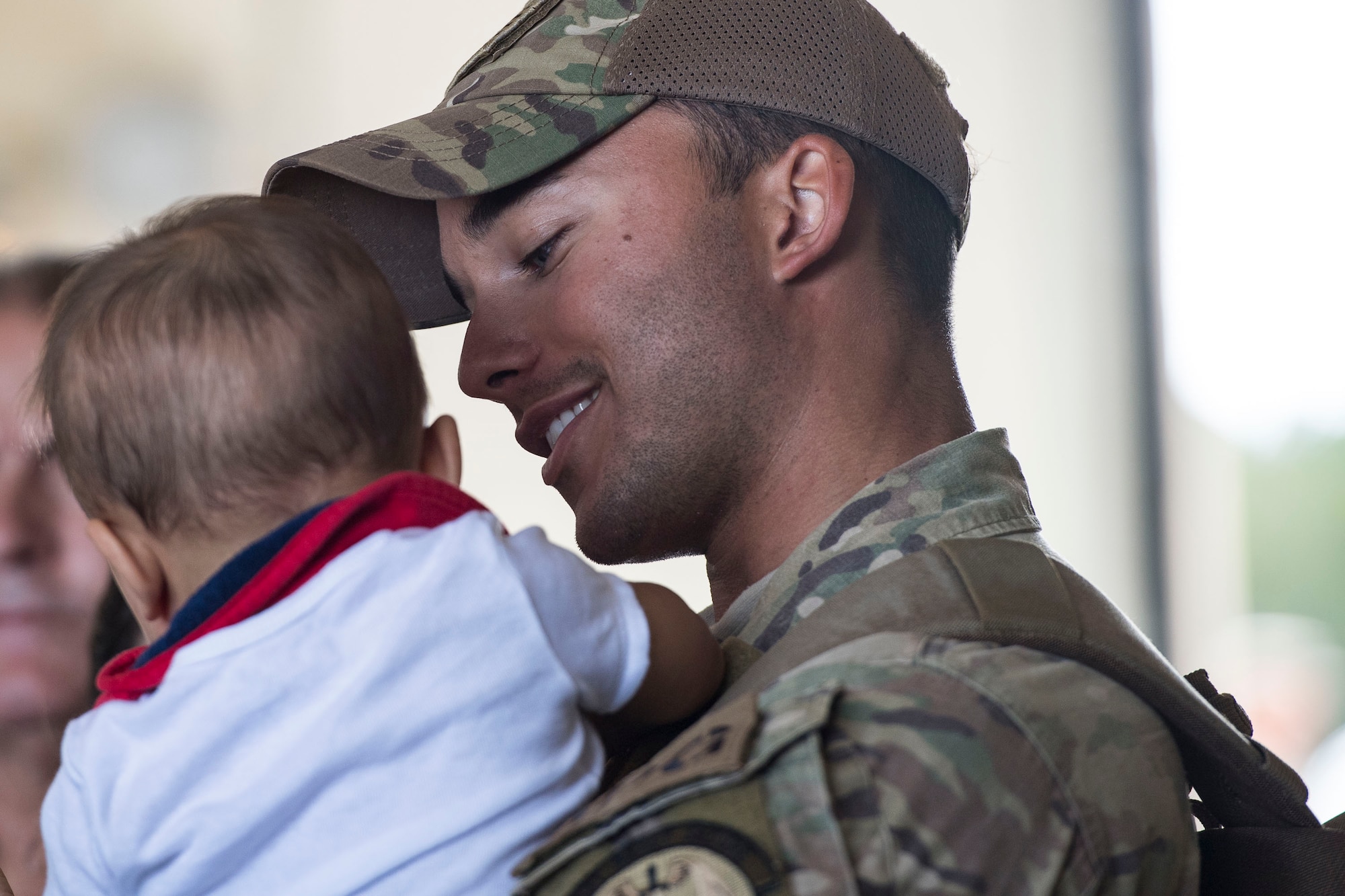 Senior Airman Brandon Boise, 823d Base Defense Squadron (BDS) fireteam member, holds his son during a redeployment, Oct. 26, 2017, at Moody Air Force Base, Ga. The 822d, 823d and 824th BDS’s provide high-risk force protection and integrated base defense for expeditionary air forces. Airmen from the 823d BDS just returned home from conducting relief-in-place in the United States Africa Command theater while Airmen from the 824th BDS took their place. (U.S. Air Force photo by Senior Airman Janiqua P. Robinson)
