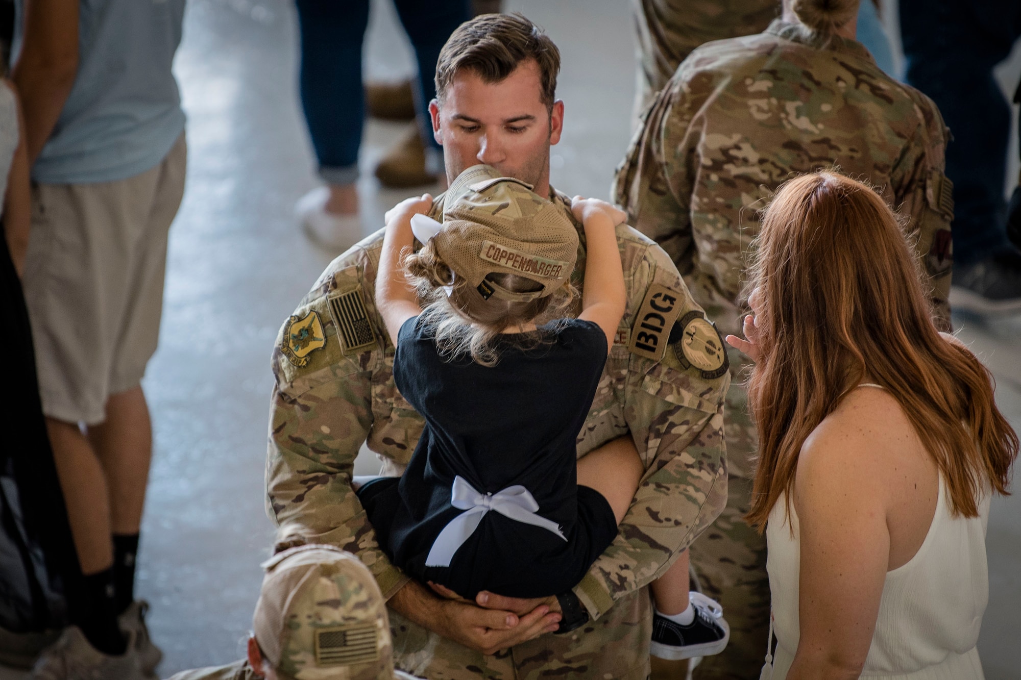 Tech. Sgt. Cliff Coppenbarger, 823d Base Defense Squadron (BDS) squad leader, holds his daughter during a redeployment ceremony, Oct. 26, 2018, at Moody Air Force Base, Ga. The 822d, 823d and 824th BDS’s provide high-risk force protection and integrated base defense for expeditionary air forces. Airmen from the 823d BDS just returned home from conducting relief-in-place in the United States Africa Command theater while Airmen from the 824th BDS took their place. (U.S. Air Force photo by Airman Taryn Butler)