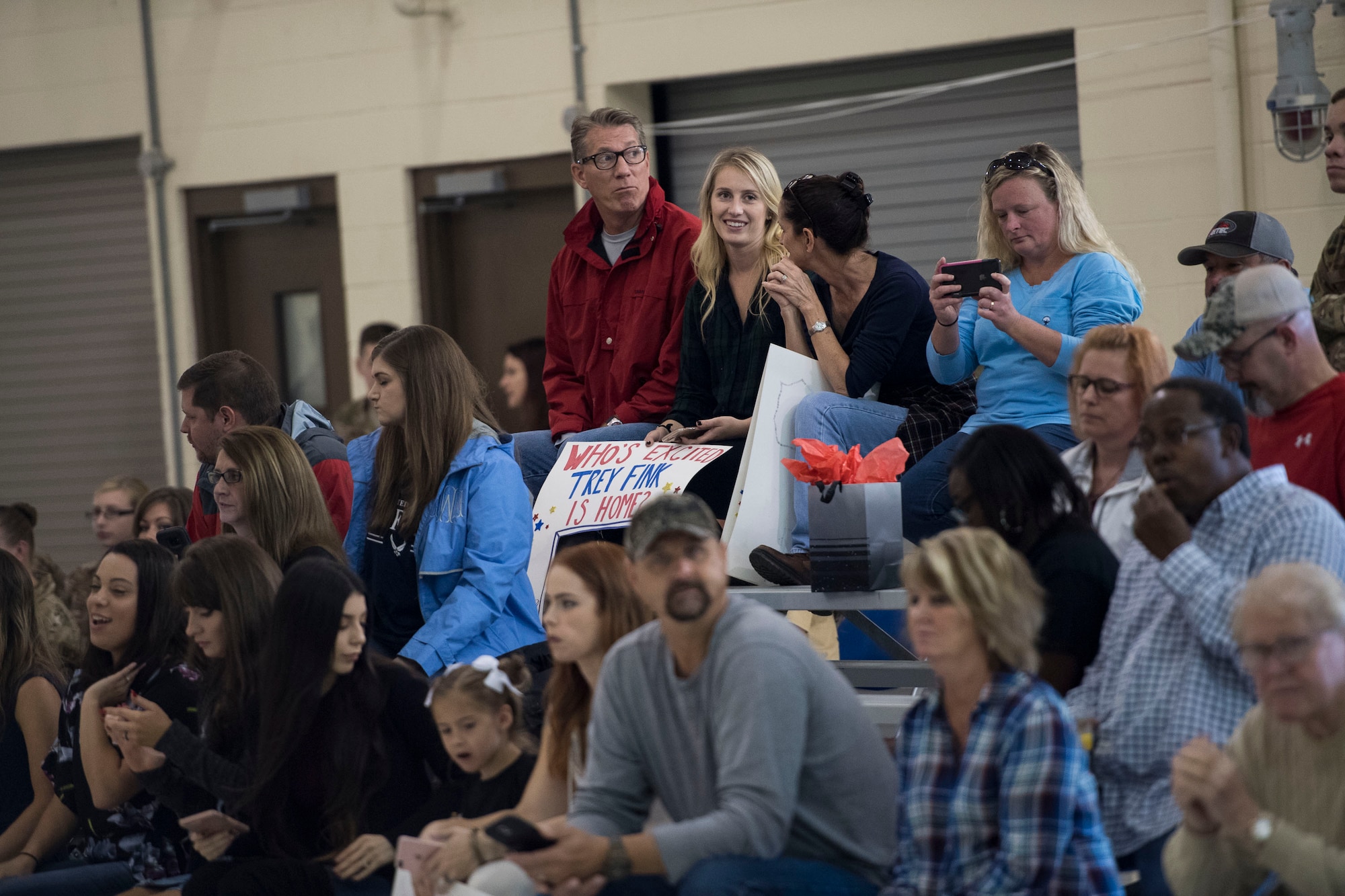 Family and friends of Airmen assigned to the 823d Base Defense Squadron (BDS) socialize during a redeployment, Oct. 26, 2017, at Moody Air Force Base, Ga. The 822d, 823d and 824th BDS’s provide high-risk force protection and integrated base defense for expeditionary air forces. Airmen from the 823d BDS just returned home from conducting relief-in-place in the United States Africa Command theater while Airmen from the 824th BDS took their place. (U.S. Air Force photo by Senior Airman Janiqua P. Robinson)