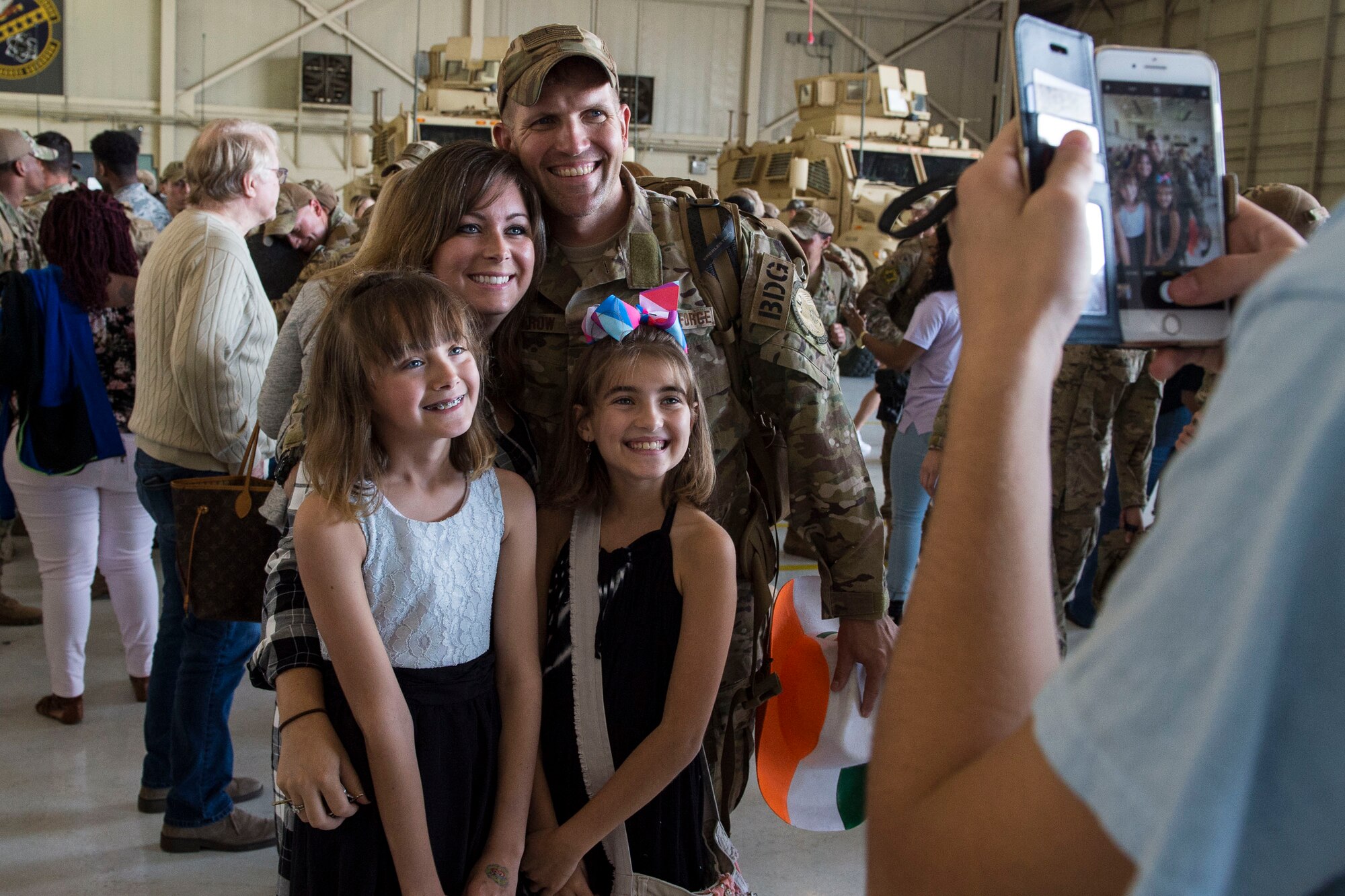 Master Sgt. Robert Renfrow, 823d Base Defense Squadron (BDS), poses for a photo with his family during a redeployment, Oct. 26, 2017, at Moody Air Force Base, Ga. The 822d, 823d and 824th BDS’s provide high-risk force protection and integrated base defense for expeditionary air forces. Airmen from the 823d BDS just returned home from conducting relief-in-place in the United States Africa Command theater while Airmen from the 824th BDS took their place. (U.S. Air Force photo by Senior Airman Janiqua P. Robinson)
