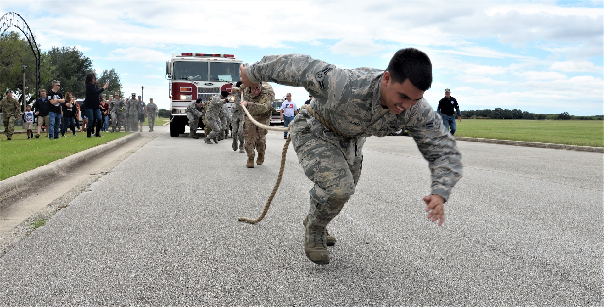 Airman 1st Class Jared Tajalle, 902nd Security Forces Squadron patrolman, and fellow 902nd SFS members pull a fire truck Oct. 20, 2018, during the final challenge of the 2018 Battle of the Badges at Eberle Park, Joint Base San Antonio-Randolph, Texas. Battle of the Badges takes place each year to build camaraderie, espirit de corps and cohesion among JBSA first responders through various competitive challenges taken from their daily missions.