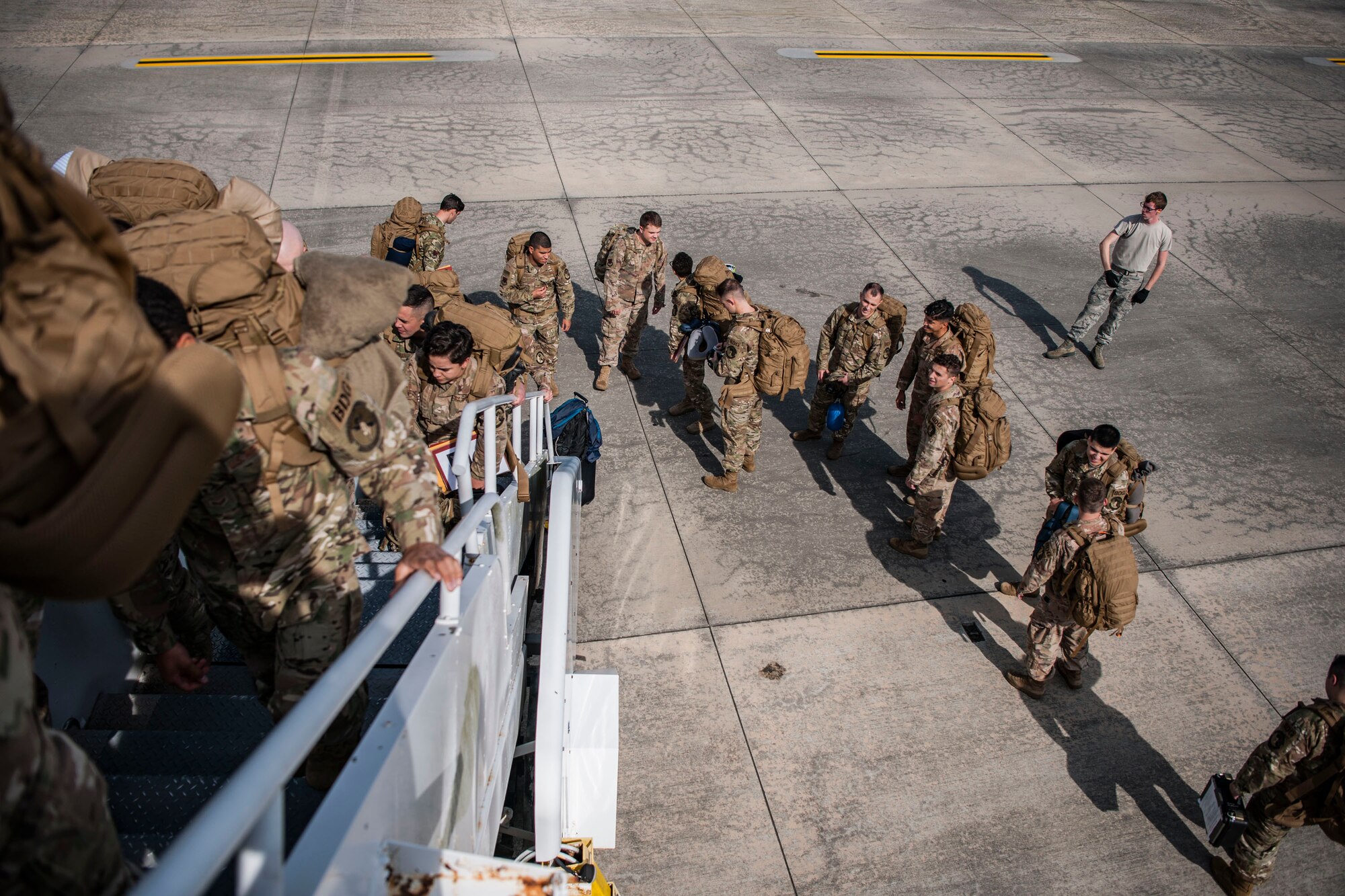 Airmen from the 824th Base Defense Squadron board an aircraft, Oct. 24, 2018, at Moody Air Force Base, Ga. The 822d, 823d and 824th Base Defense Squadrons (BDS) provide high-risk force protection and integrated base defense for expeditionary air forces. Airmen from the 823d BDS just returned home from conducting relief-in-place in the United States Africa Command theater while Airmen from the 824th BDS took their place. (U.S. Air Force photo by Airman Taryn Butler)