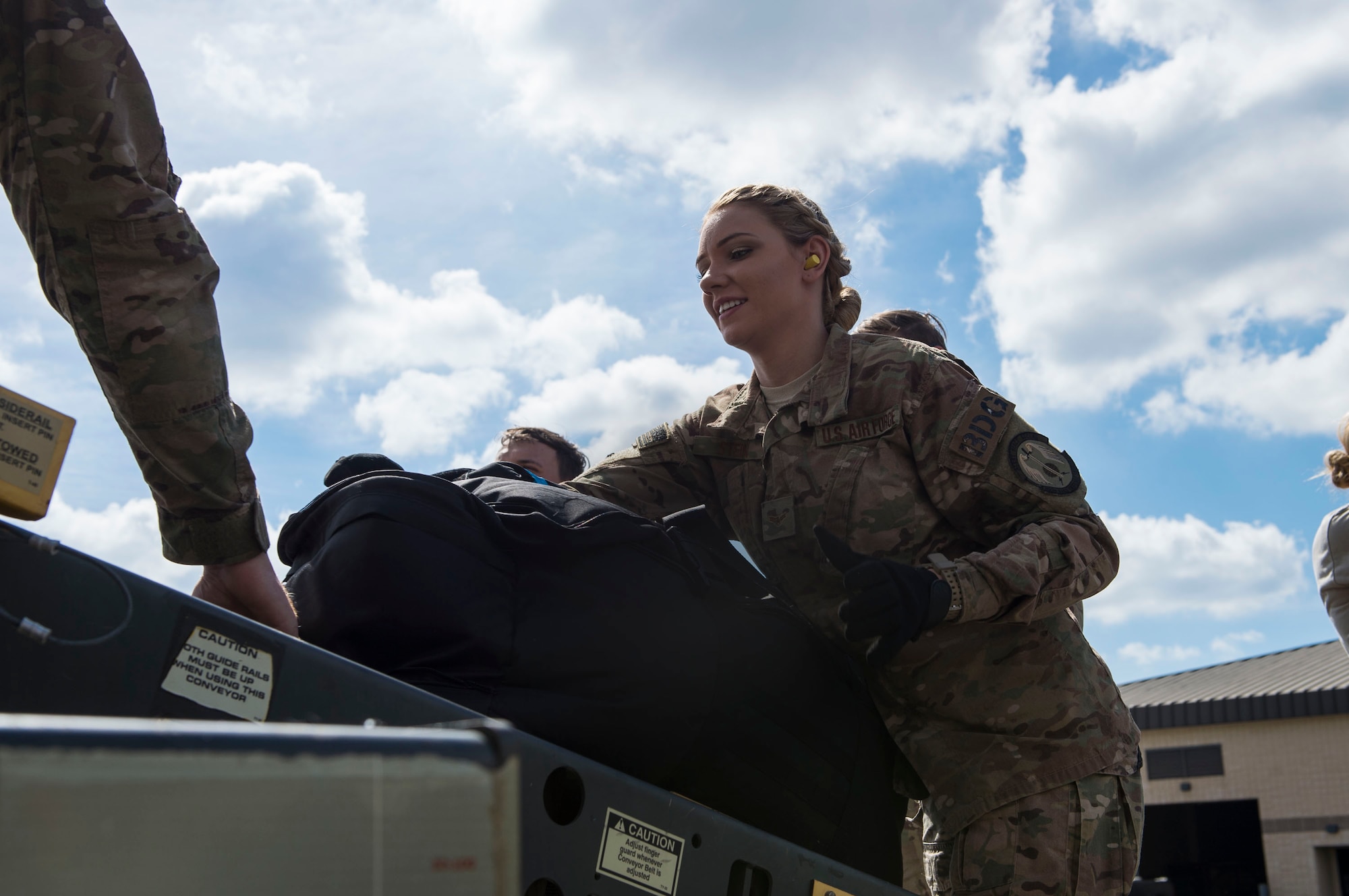 Airman 1st Class Brandy Stein, 823d Base Defense Squadron (BDS) fireteam member, places a bag onto a conveyor belt, 0ct. 24, 2018, at Moody Air Force Base, Ga. The 822d, 823d and 824th BDS’s provide high-risk force protection and integrated base defense for expeditionary air forces. Airmen from the 823d BDS just returned home from conducting relief-in-place in the United States Africa Command theater while Airmen from the 824th BDS took their place. (U.S. Air Force photo by Senior Airman Janiqua P. Robinson)