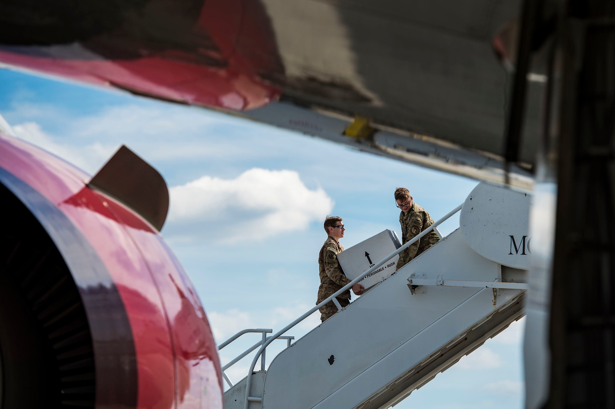 Airmen from the 820th Base Defense Group carry boxes onto a Boeing 767-300ER, 0ct. 24, 2018, at Moody Air Force Base, Ga. The 822d, 823d and 824th Base Defense Squadrons (BDS) provide high-risk force protection and integrated base defense for expeditionary air forces. Airmen from the 823d BDS just returned home from conducting relief-in-place in the United States Africa Command theater while Airmen from the 824th BDS took their place. (U.S. Air Force photo by Senior Airman Janiqua P. Robinson)