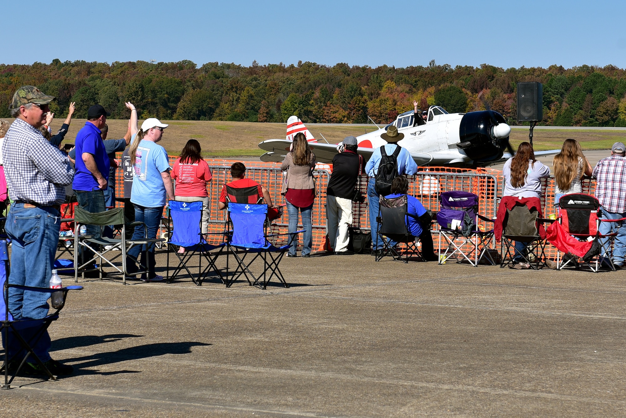 Pilot sitting in Plane waving to crowd