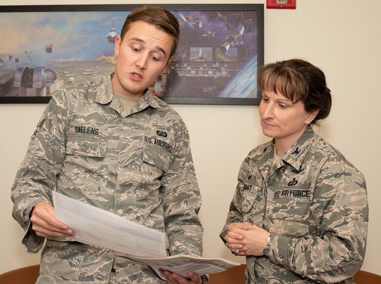 Senior Airman Nathan Saelens, 50th Comptroller Squadron financial service operator, briefs Col. Jennifer Grant, 50th Space Wing commander on The Combined Federal Campaign at Schriever Air Force Base, Colorado, Oct. 18, 2018. The campaign runs until Nov. 15. The CFC is a once-a-year federal agency wide campaign that gives federal employees and military members the opportunity to easily and securely donate to reputable charities of their choice via a one-time donation or via convenient payroll deductions. CFC representatives are required to make 100 percent face-to-face contact with 50th SW Airmen. (U.S. Air Force photo by Staff Sgt. Matthew Coleman-Foster)