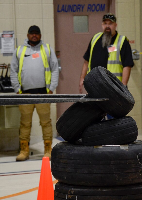 Material Examiner and Identifier Eric Thorne, from Norfolk, and Property Disposal Specialist Todd Lutter, from the Kaiserslautern site in Germany, watch during a MHE Rodeo skills challenge event at the DLA Disposition Services expeditionary support facility in Battle Creek, Michigan.