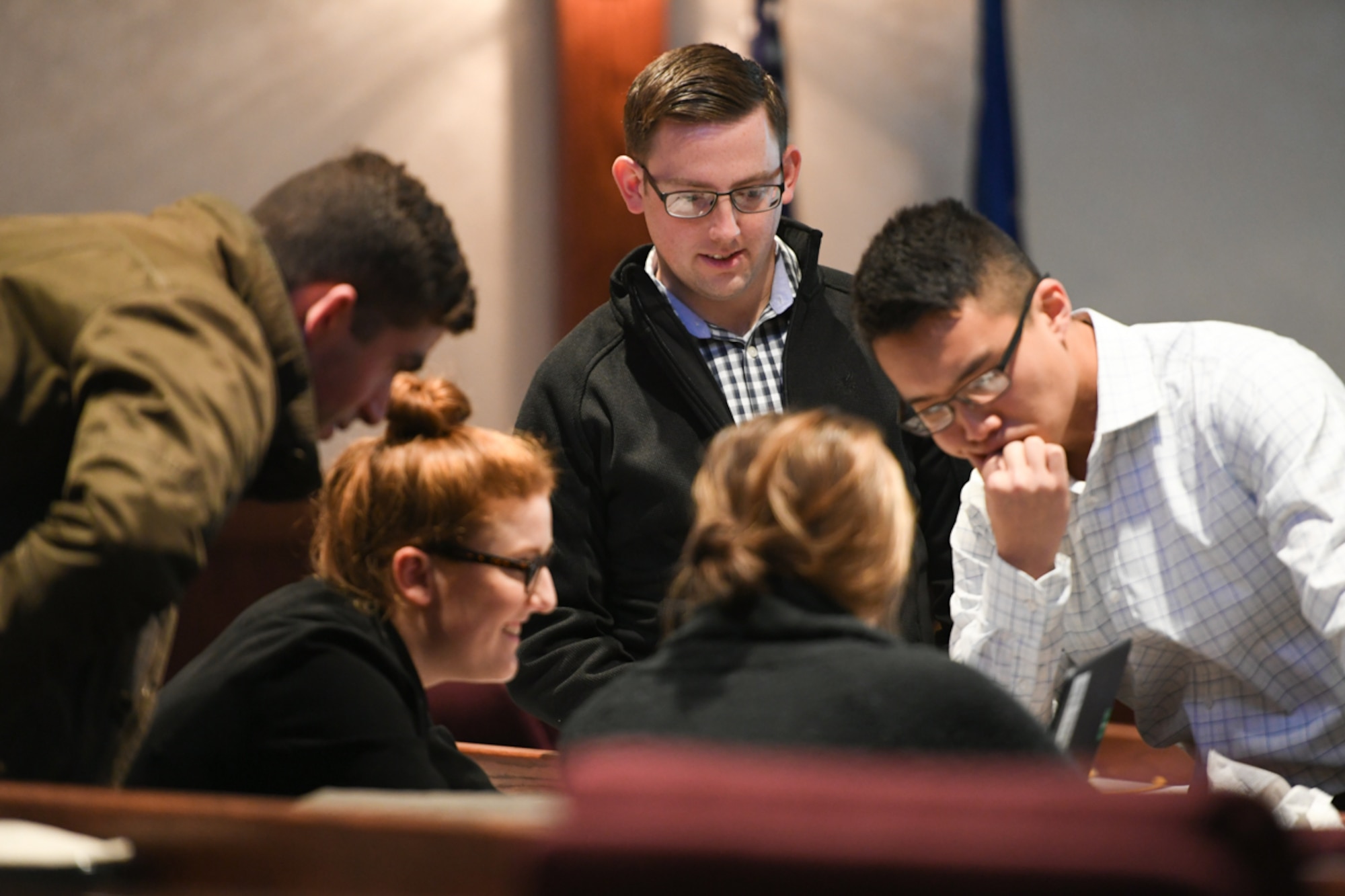 Attendees, including military members in civilian attire, at the 2018 Hanscom Air Force Base Revolutionary Acquisition Techniques, Procedures and Collaboration (RATPAC) Fractal event pore over a challenge problem, Oct. 25, in the Hanscom Conference Center, Hanscom Air Force Base, Mass. Organizers said business casual clothes encouraged attendees to freely exchange of ideas during the academic challenge portion. (U.S. Air Force photo by Todd Maki)