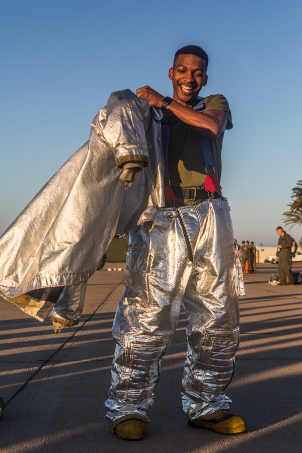Sgt. Troy K. Gordley, admin clerk with Headquarters and Headquarters Squadron (H&HS), puts on a fire proximity suit during a warrior challenge at Marine Corps Air Station Miramar, Calif., Nov. 26. The warrior challenge is held every month by H&HS to build unit cohesion and boost morale through various unit competitions. (U.S. Marine Corps photo by Cpl. Becky Cleveland)
