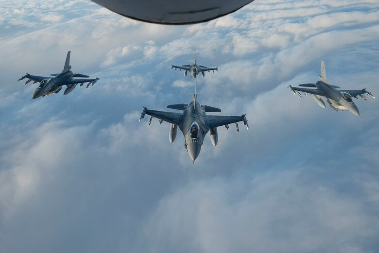 Four Belgian Air Force F-16 Fighting Falcons fly in formation behind a U.S. Air Force KC-135 Stratotanker during Exercise Trident Juncture 18, in Swedish airspace, Oct. 30, 2018. The NATO-led exercise includes 31 countries and provides unique opportunities to train with NATO allies and partners. (U.S. Air Force photo by Senior Airman Luke Milano)