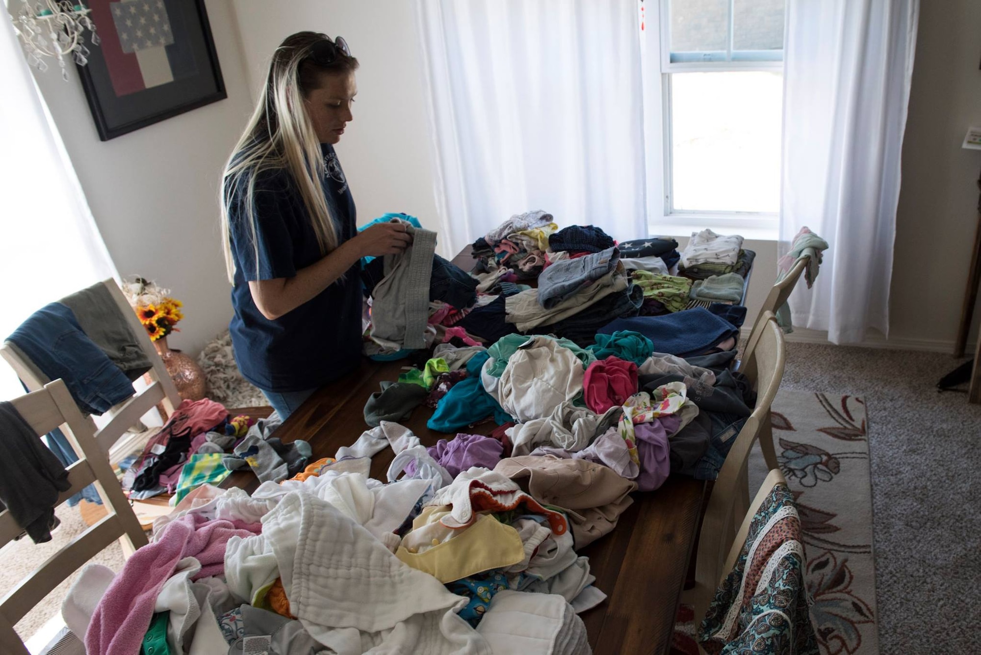 Heather Kriete salvages her children's clothes in her home, at Tyndall Air Force Base, Fla., Oct. 19, 2018. Tyndall AFB was damaged by Hurricane Michael which displaced approximately 11,000 people, including the Kriete family who travelled to Tyndall during a five hour window to recover their belongings.