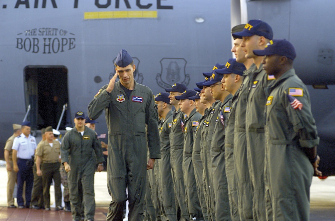 One of 24 Airmen on U.S. Navy EP-3 aircraft involved in April 1 accident with Chinese F-8 aircraft salutes as he departs C-17 Globemaster III, while en
route to Hickam Air Force Base, Hawaii, April 12, 2001 (U.S. Air Force/Adrian Cadiz)