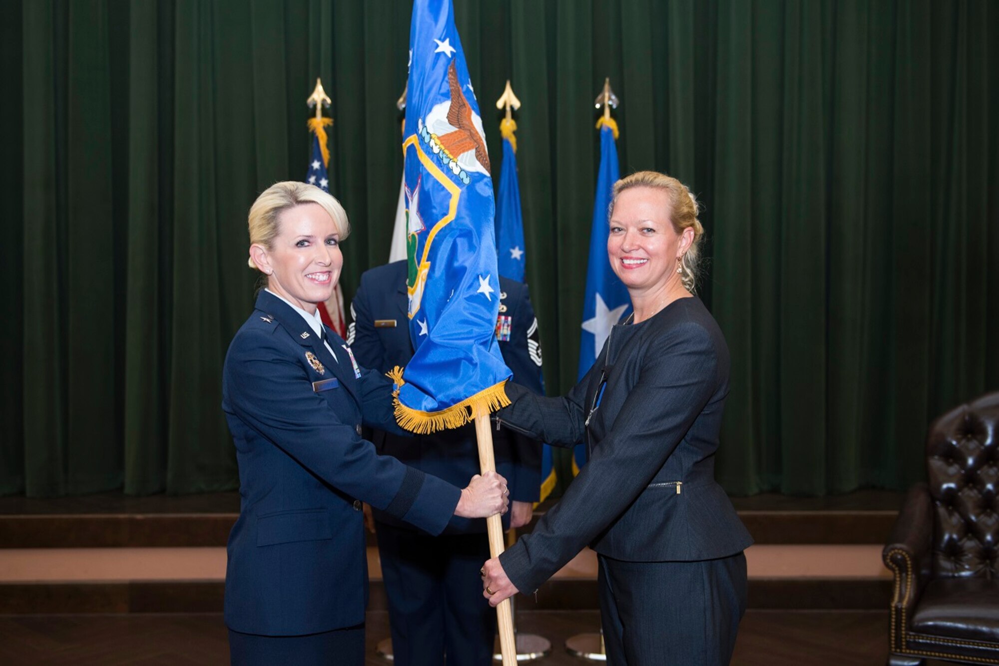 U.S. Air Force Brig. Gen. Laura L. Lenderman, 502d Air Base Wing and Joint Base San Antonio commander, presents the 502d Civil Engineer Group guidon to Brenda L.  Roesch as she takes command during an activation ceremony Oct. 25, 2018, at Joint Base San Antonio-Lackland, Texas.