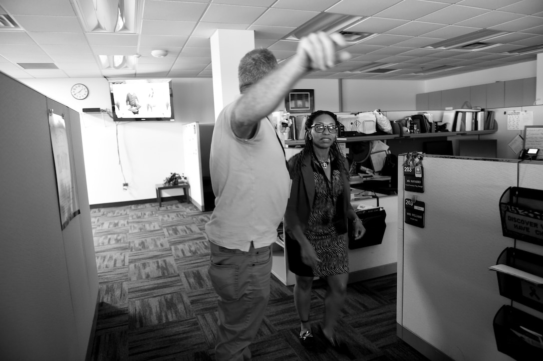 David Lietz, left, Family Readiness Support Assistant, 85th Support Command, directs staff to a more secure area during an active shooter training exercise at the command headquarters, Oct. 30, 2018.