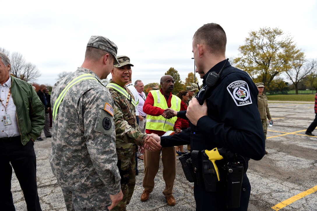 Army Reserve Soldiers, assigned to the 85th Support Command’s force protection G3 staff, thank police officers, from the Arlington Heights Police Department, for their participation following an active shooter training exercise at the command headquarters, Oct. 30, 2018.