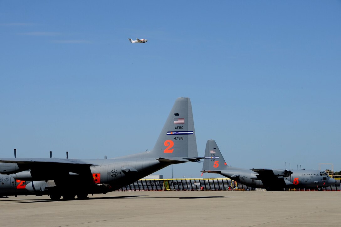 Two C-130 Hercules aircraft assigned to the 302nd Airlift Wing at Peterson Air Force Base, Colorado, participate in the annual U.S. Department of Agriculture Forest Service Modular Airborne Fire Fighting System recertification training, April 23, 2018, at the McClellan Reload Base, California.