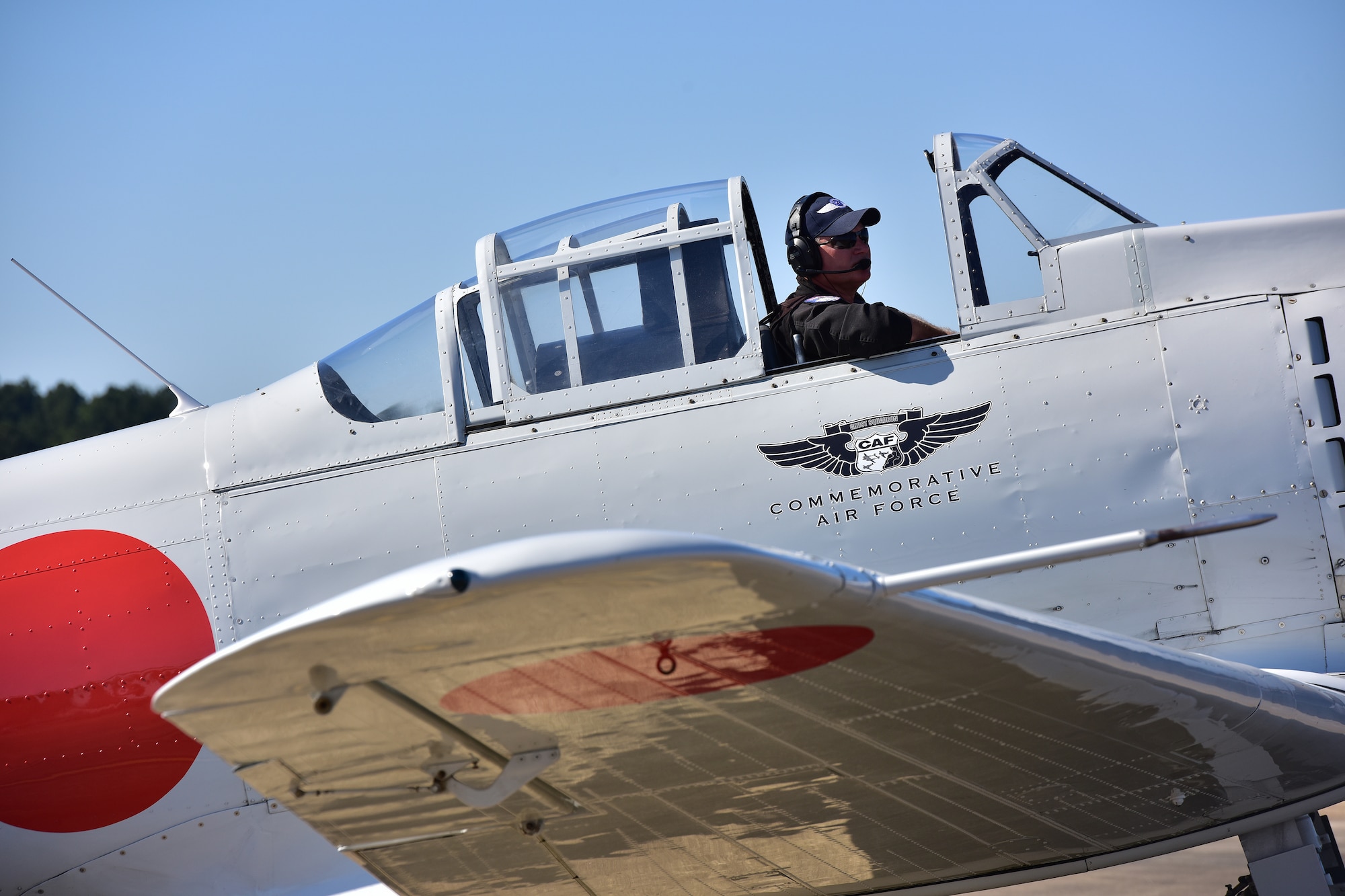 man sitting in plane with hatch open