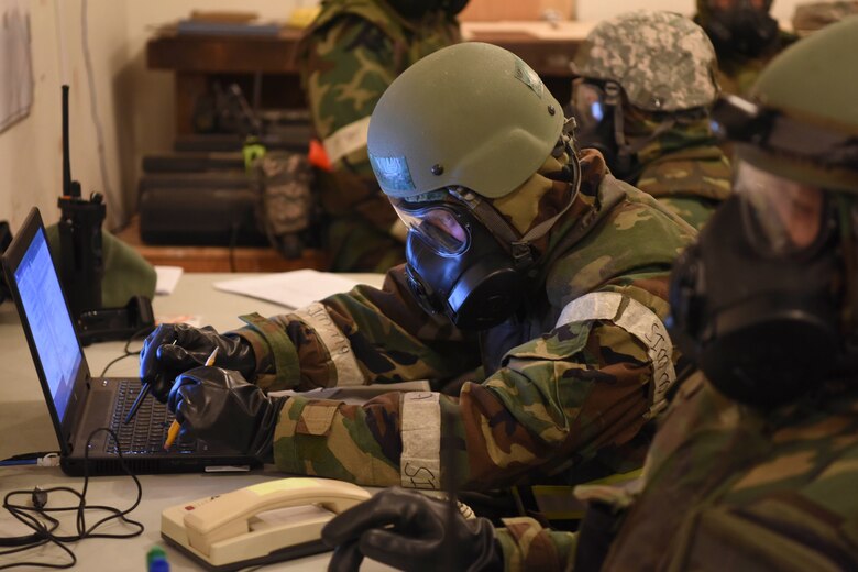 U.S. Air Force Senior Airman Landon Heartsill, 773d Civil Engineer Squadron, uses two pencils to input information on a computer during a mock chemical attack during exercise Polar Force 19-1 at Joint Base Elmendorf-Richardson, Alaska, Oct. 24, 2018. Exercise Polar Force showcases unit combat readiness while fighting in chemical, biological, radiological and nuclear defense protective gear.