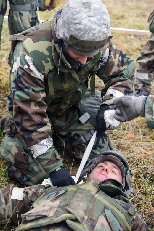 U.S. Air Force Staff Sgt. Zachary Roberts, 773d Civil Engineer Squadron, performs first aid on Airman 1st Class Travis Bittle, 773d CES, during exercise Polar Force 19-1 at Joint Base Elmendorf-Richardson, Alaska, Oct. 24, 2018. Exercise Polar Force showcases unit combat readiness while fighting in chemical, biological, radiological and nuclear defense protective gear.